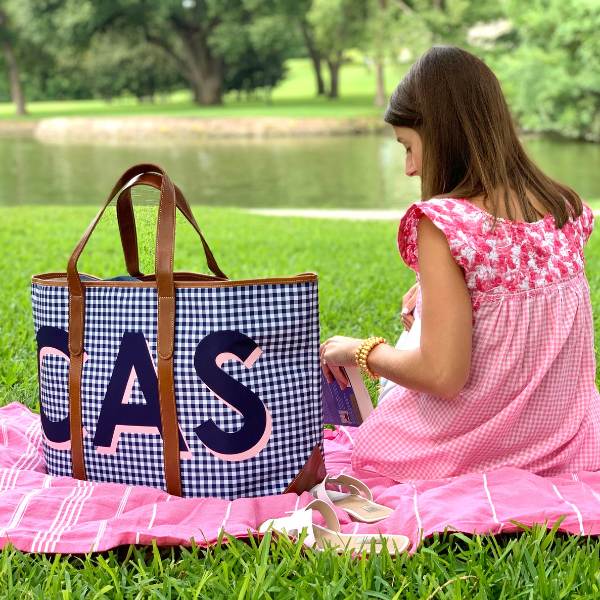 having a picnic using a monogrammed tote as a picnic basket